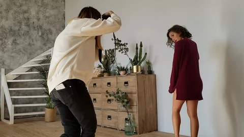 Young Mixed Model is Posing for the Photographer in a Studio Stock Footage 122988664