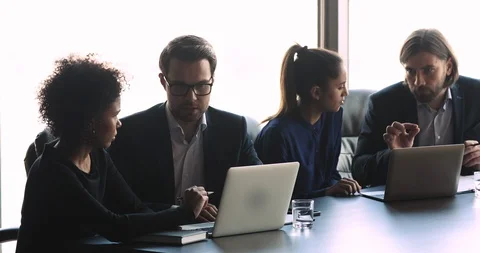 Young mixed race business people working in small groups. Stock Footage