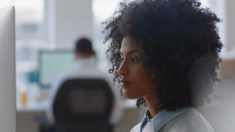 Young mixed race business woman using computer brainstorming problem solving Stock Footage