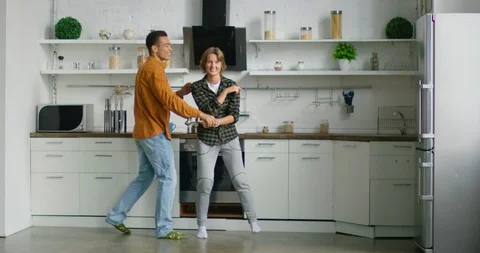 Young mixed race couple is dancing in kitchen Stock Footage 114641544