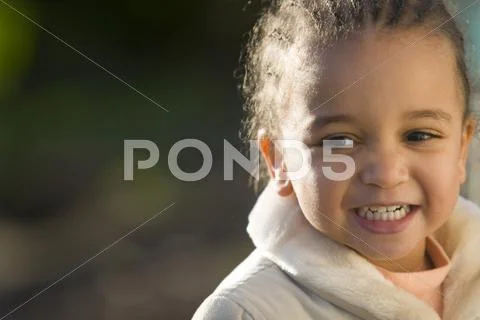 Young mixed race girl laughing and happy Stock Photos