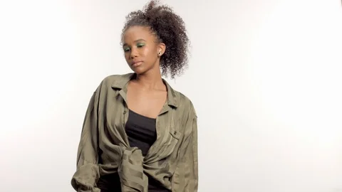 Young mixed race model in studio on white with curly hair, bright green eye Stock Footage 111317964