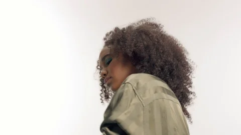 Young mixed race model in studio on white with curly hair, bright green eye Stock Footage 111318401