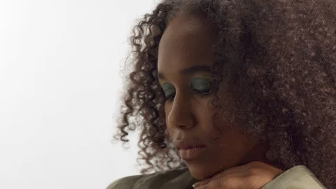 Young mixed race model in studio on white with curly hair, bright green eye Stock Footage 111318827
