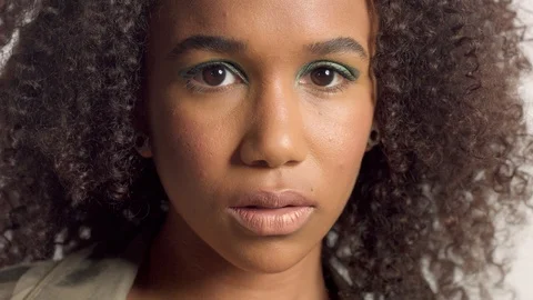 Young mixed race model in studio on white with curly hair, bright green eye Stock Footage 111319079