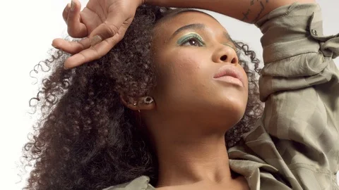 Young mixed race model in studio on white with curly hair, bright green eye Stock Footage 111319387
