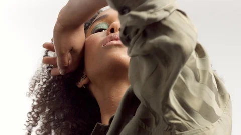 Young mixed race model in studio on white with curly hair, bright green eye Stock Footage 111319535