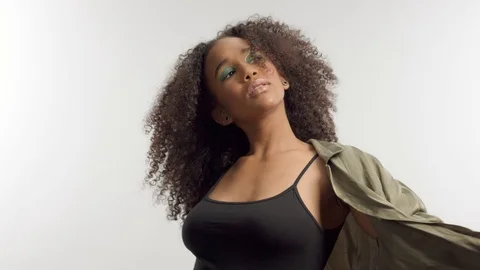 Young mixed race model in studio on white with curly hair, bright green eye Stock Footage 111320012