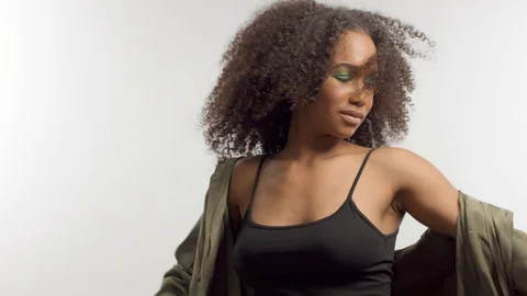 Young mixed race model in studio on white with curly hair, bright green eye Stock Footage 111320449