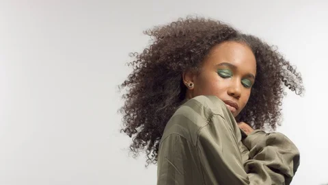 Young mixed race model in studio on white with curly hair, bright green eye Stock Footage 111320786