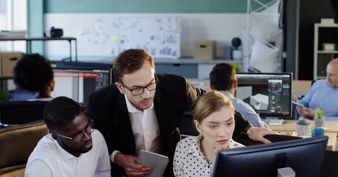 Young mixed-races couple of office co-workers discussing with a senior manager Stock Footage 82446465