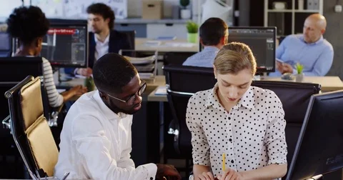 Young mixed races employees working on the computer and being checked by their Stock Footage 82444893