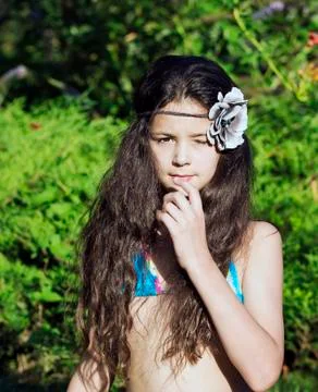 The young model closes one eye, looks thoughtfully into the camera. Stock Photos