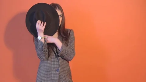 Young model hides face behind the hat and posing Stock Footage 73341097