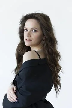 Young model looking over shoulder with long brown hair. Vertical plane. Stock Photos