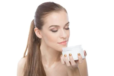 Young model opening moisturizer Stock Photos