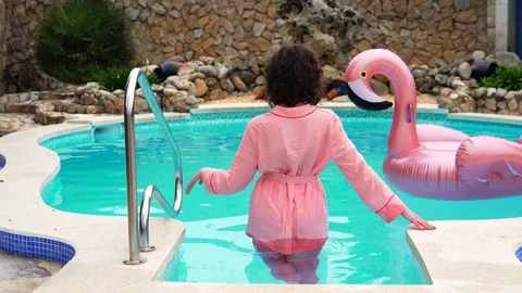 Young model poses waist-deep in the water leaves swimming pool Stock Footage 114193900