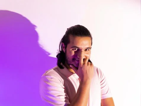 Young model posing in a studio in a trendy neon light. Stock Photos