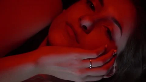 Young model is posing from underwater in red lighting, close up Stock Footage 138004058