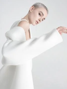 Young model putting on white jacket Stock Photos