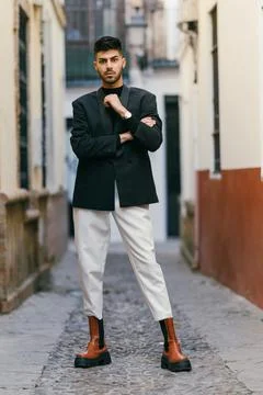 Young model standing looking at the camera with fashion clothes outdoors Stock Photos