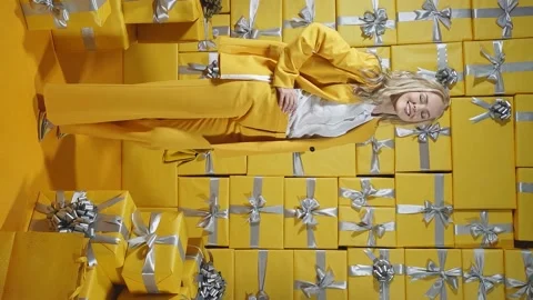 A young model in a stylish yellow suit poses in front of the camera in full Stock Footage 162543000
