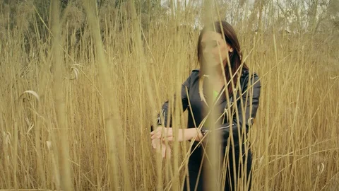 Young Model Walking Trough High Grass Stock Footage 129522092