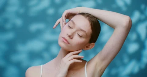 A young model without makeup posing on a studio touching her face Stock Footage 168073667