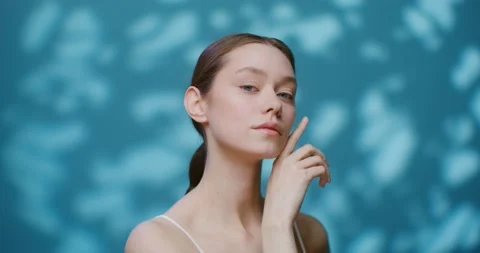 A young model without makeup posing on a studio touching her face Stock Footage 168074757