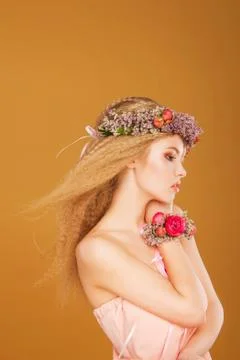 Young model with wreath of bright flowers on her head Stock Photos
