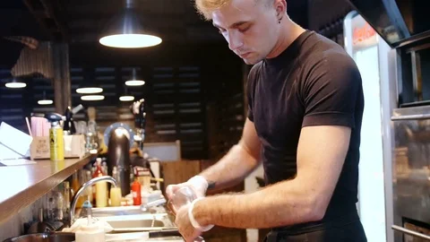 Young modern chef prepares meat before grilling 動画素材 78730373