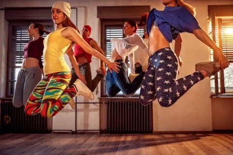 Young modern dancers dancing in the studio. Sport, dancing and urban culture  Stock Photos