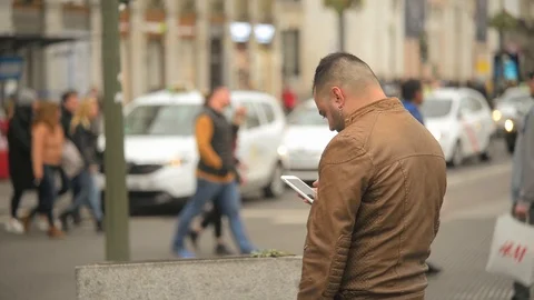 A Young Modern Man use Mobile Phone on a Street in Center of Madrid, Spain Stock Footage 105787283
