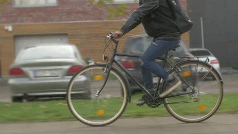 Young modern office worker commuting by bike on city street outdoor Stock Footage 133302503
