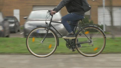 Young modern office worker commuting by bike on city street outdoor Stock Footage 133303534