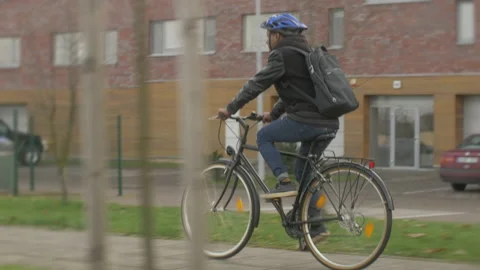 Young modern office worker commuting by bike on city street outdoor Stock Footage 133305831