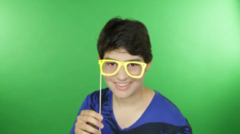 Young modish smart dude does humorous actions with a funny spectacles Stock Footage 22845982