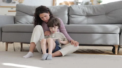 Young mom and kid son use digital tablet together play game, do online shopping Stock Footage 157342255