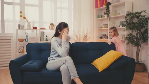 Young mom feeling tired because of hyperactive child, parenting challenges Stock Footage 233115530