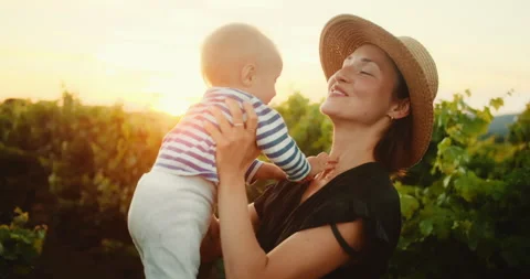 Young Mom have fun time with her cute little child in French Provence vineyard 動画素材 203839771