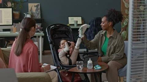 Young Mom Having Talk with Office Colleague while Baby Sitting in Stroller Stock Footage 310955177