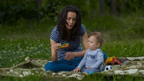 Young Mom with Little Baby Play in Garden. Stock Footage 113686953