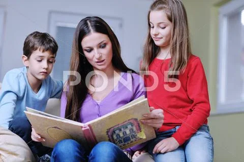 Young mom play with their kids at home and reading book Stock Photos