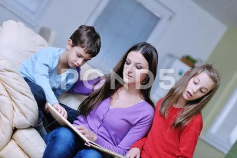 Young mom play with their kids at home and reading book Stock Photos