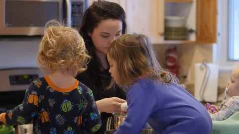 Young mom separates eggs with young children helping handing eggs Stock-Footage 86713593