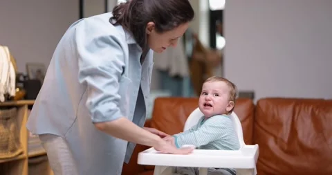 Young mom taking care of her one year crying son Stock Footage 154649960