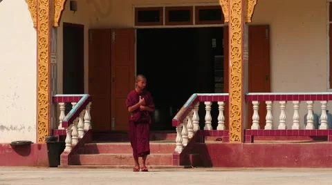 Young monk going from monastery in Myanmar slow motion Stock Footage 61206209