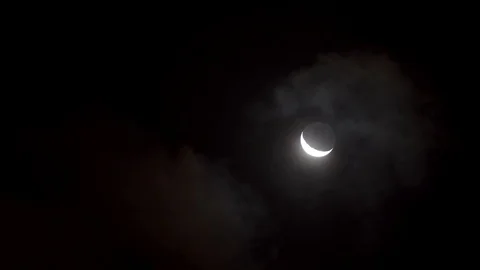 Young moon mooving through clouds at night Stock Footage 81474943