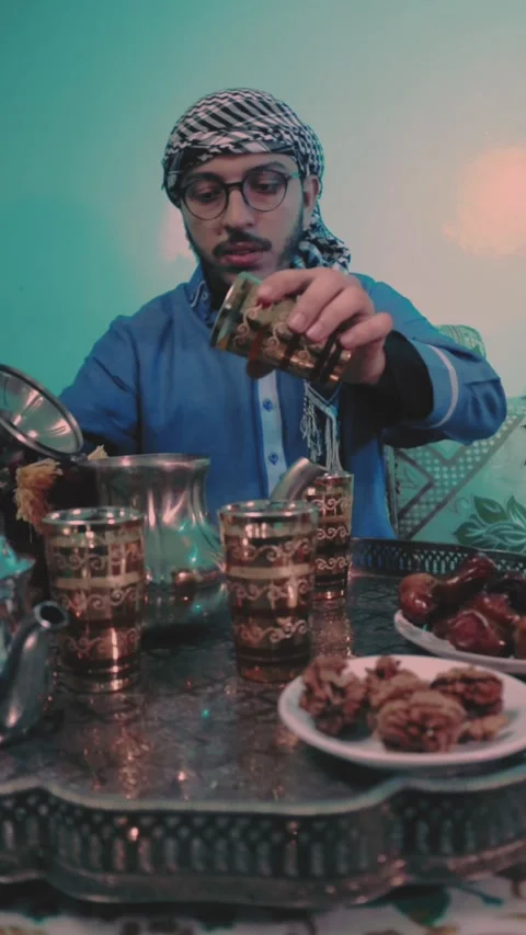 A young Moroccan man prepares tea in an Arab atmosphere. Stock Footage 303966778