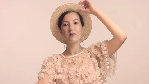 A young Moroccan woman wears a hat in the studio and monochrome makeup Stock Footage 112525053